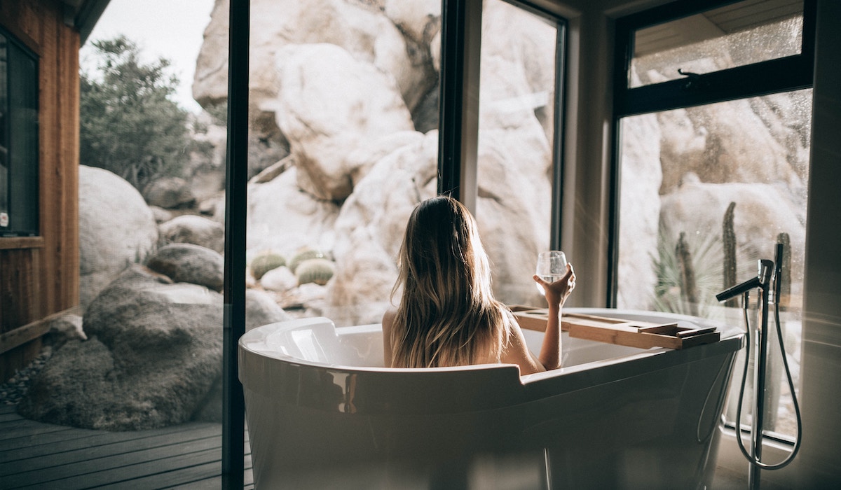woman vacation tub with wine