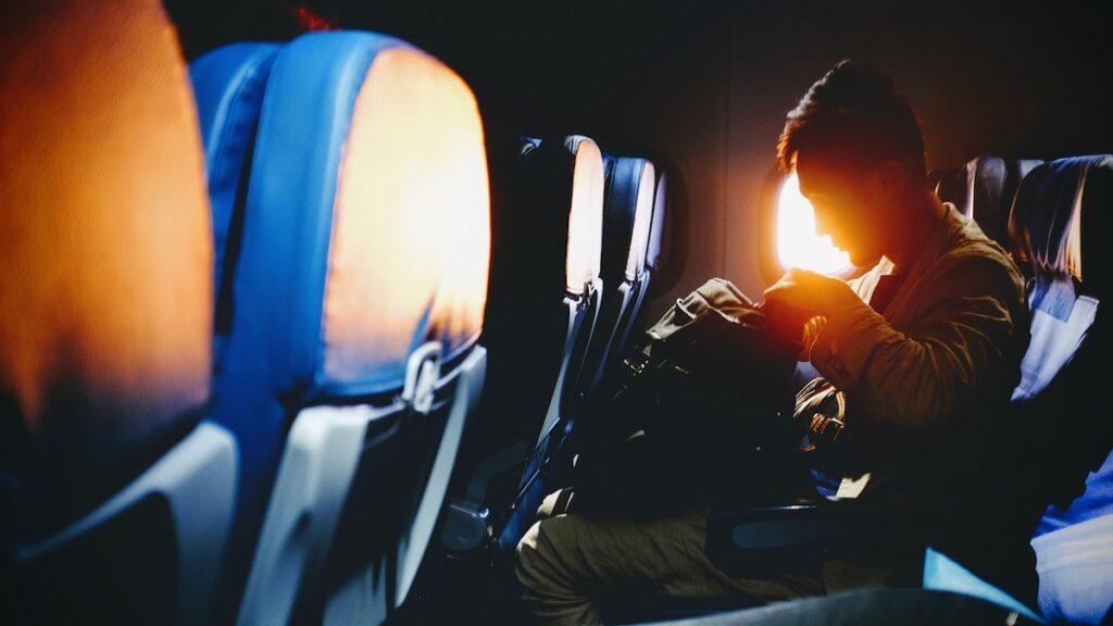 man on airplane sunset