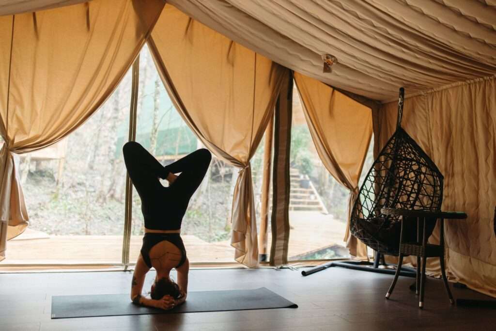 woman doing yoga in a glamping tent